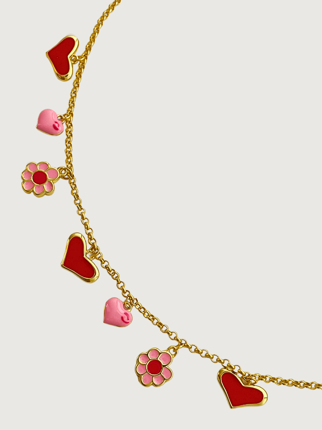 Closeup of Little Princess Hearts and Flower Charm Necklace in 18k Gold Plated Silver Adjustable Length 925 Sterling Metal 14 inches 7.2gms