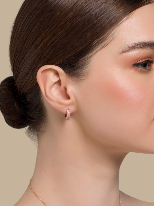 Model Wearing Lia Huggie Hoop Earrings Jewelry for Pierced Ears 18k Rose Gold Plated 925 Sterling Silver One Size 2.8gms