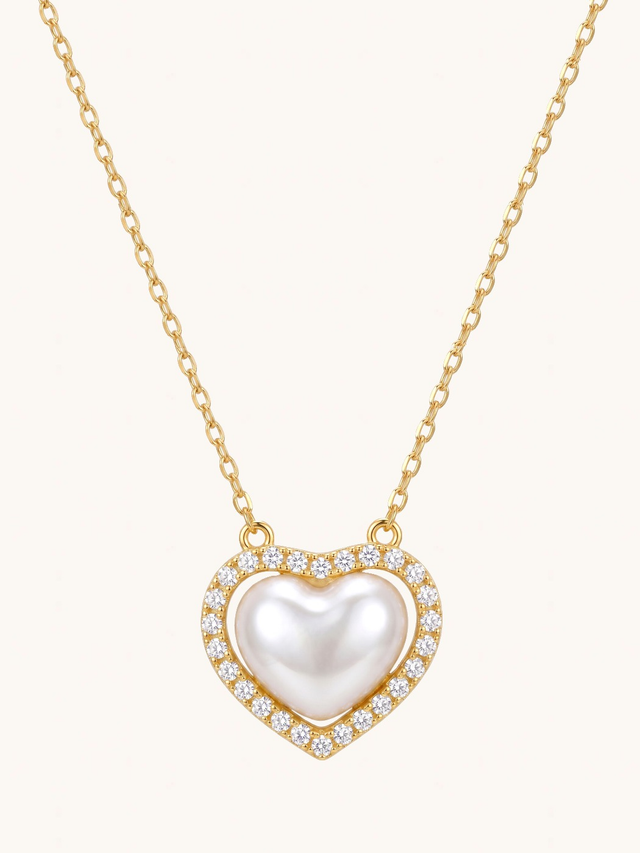 Amora Gold Heart Pendant Necklace on a plain cream background