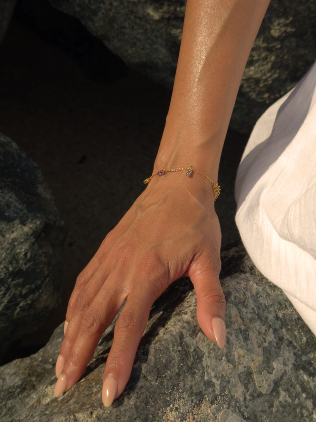 Model Wearing Kiara Charm Bracelet in 18k Gold-Plated Metal Adjustable Length Gold Plated Steel | Hypoallergenic Tarnish Resistant Sweat Water Eco - Friendly Stone One Size 1.9gms