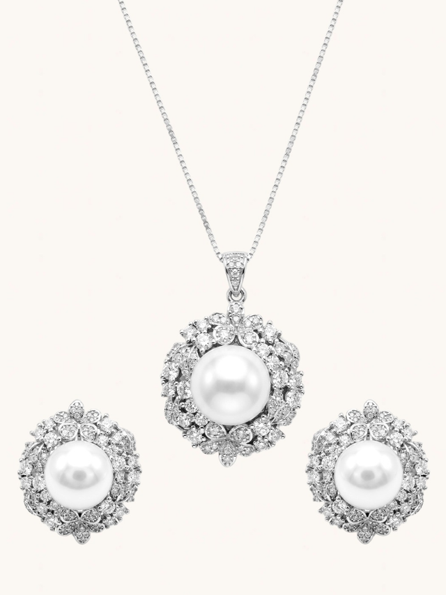 Yasmine Pearl Pendant Necklace Set on a plain cream background